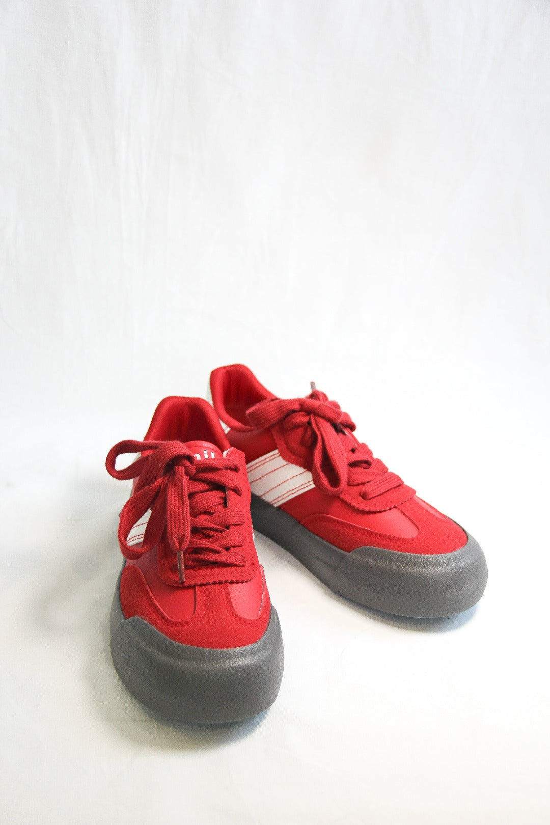 Product view of Jena Red Sneakers, front view.