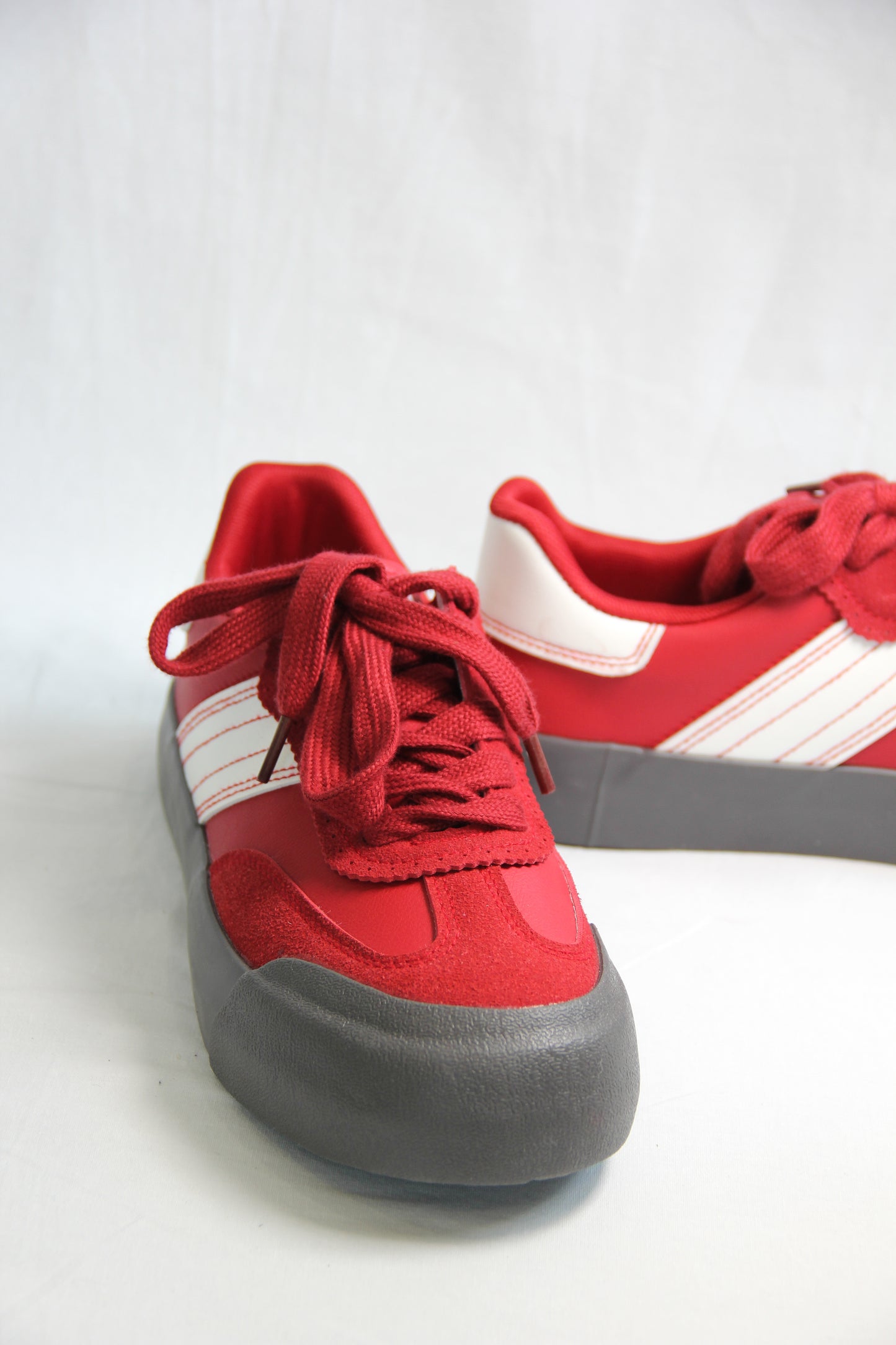 Product view of Jena Red Sneakers, front view.