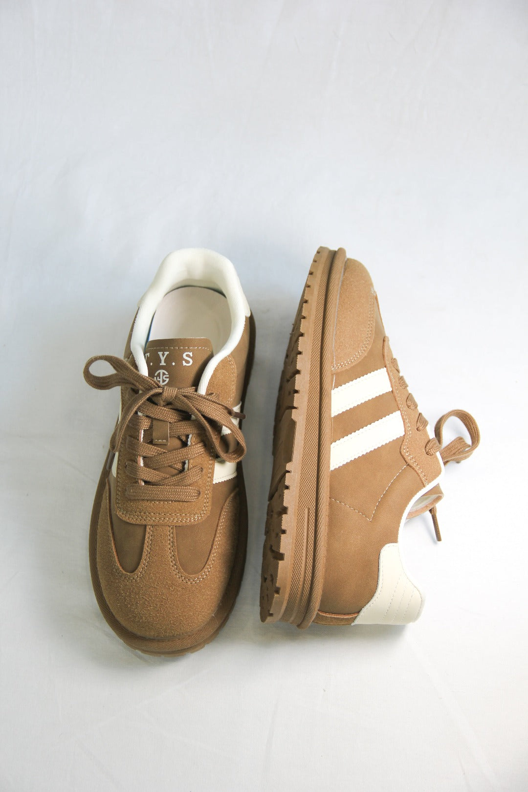 **Alt Text:** Pair of Essen Mocha Sneakers with a rich mocha brown suede and mesh upper, white stripes, and a comfortable platform sole, displayed against a plain white background.